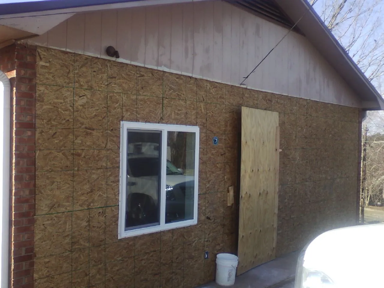OSB sheathing on a garage addition wall before siding in Aspen